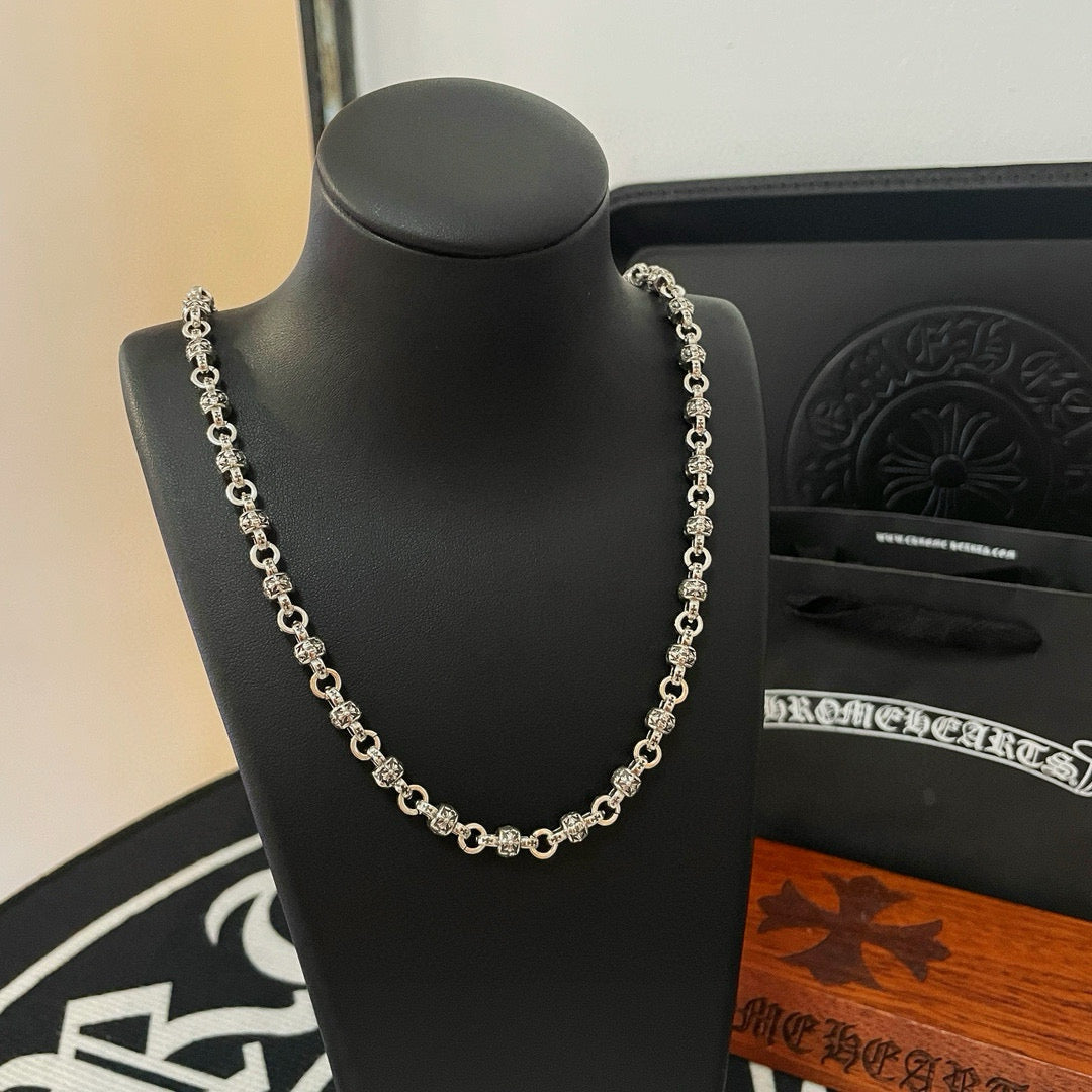 Metal chain necklace close-up on bust display