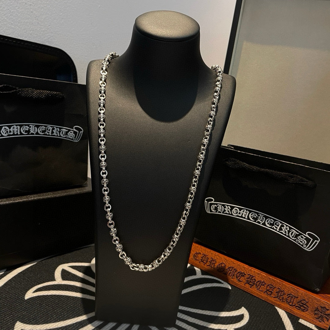 Metal chain necklace on bust display