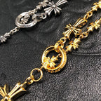 Gold chain necklace with round charm and starburst cross pendants