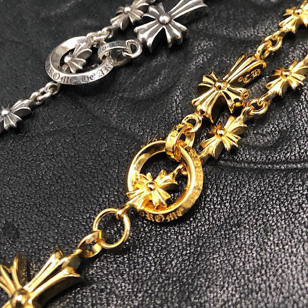 Gold chain necklace with round charm and starburst cross pendants