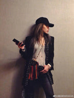 Gold and silver cross pendant necklaces worn with a black jacket