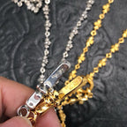 Silver and gold chain necklace clasp with engraved bar detail