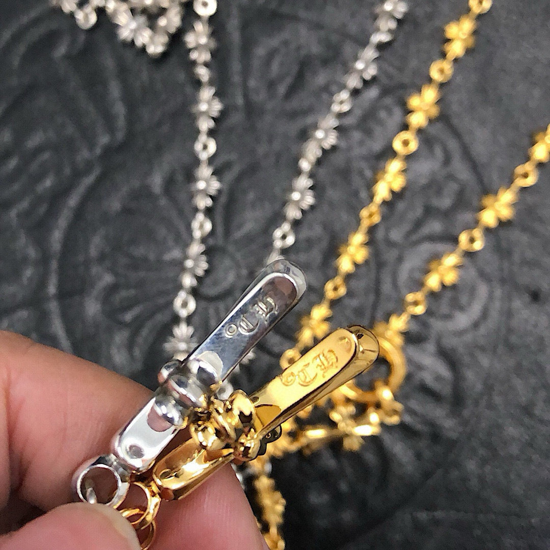 Silver and gold chain necklace clasp with engraved bar detail