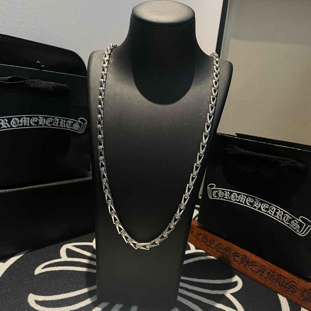 Silver-tone chain necklace shown on a black display bust, front view