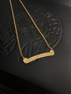 Gold-tone bar pendant necklace with chain and engraved-style bar pendant