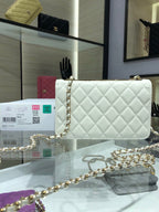 White quilted shoulder bag with gold chain strap and flap front logo turn-lock