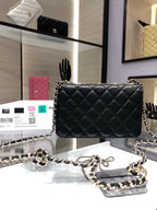 Black quilted crossbody bag with chain strap and gold Chanel emblem