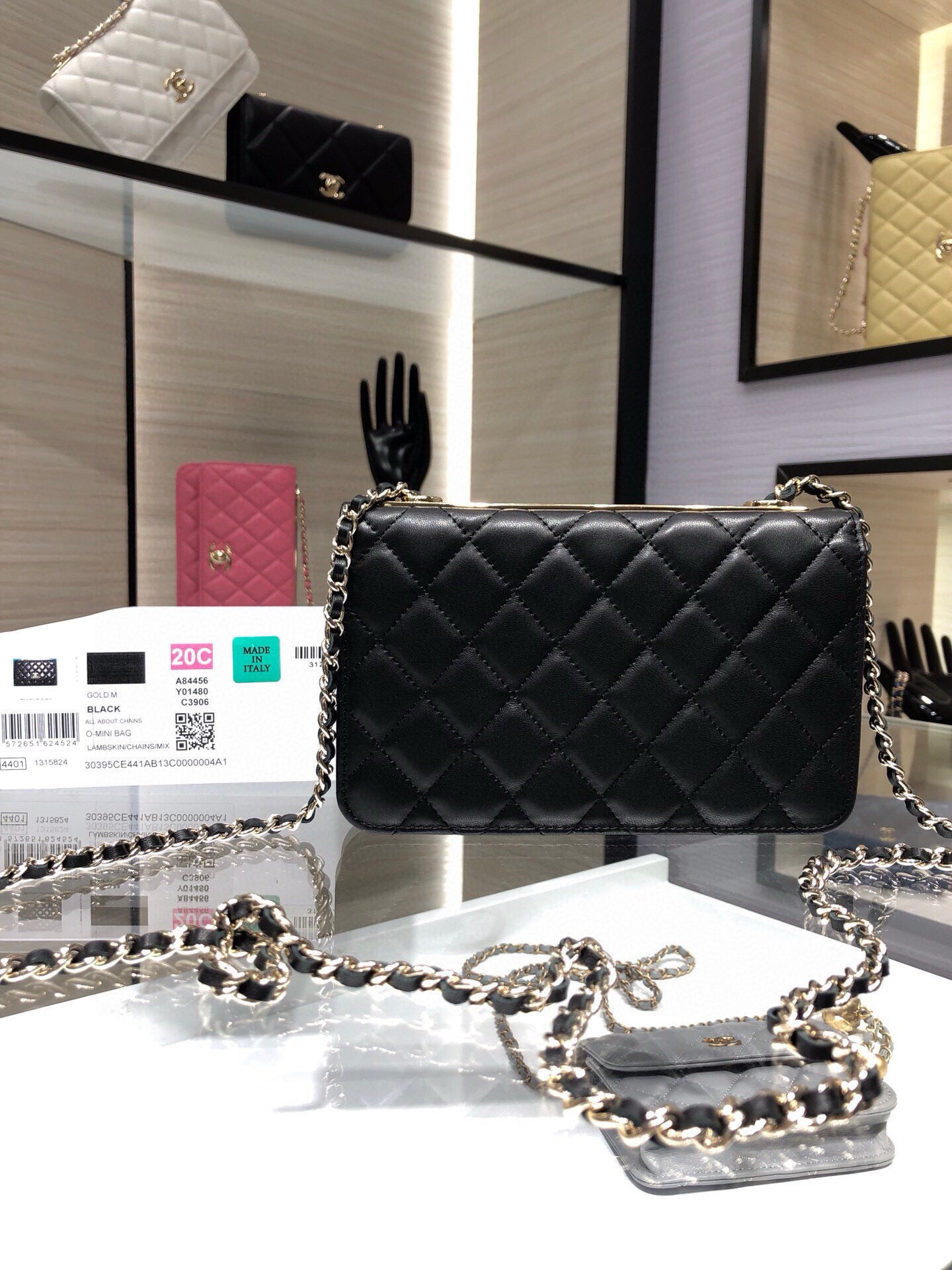 Black quilted crossbody bag with chain strap and gold Chanel emblem