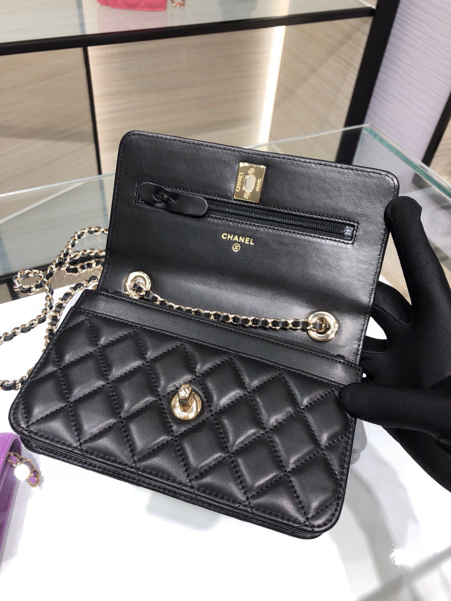 Black quilted Chanel shoulder bag with gold hardware and chain strap