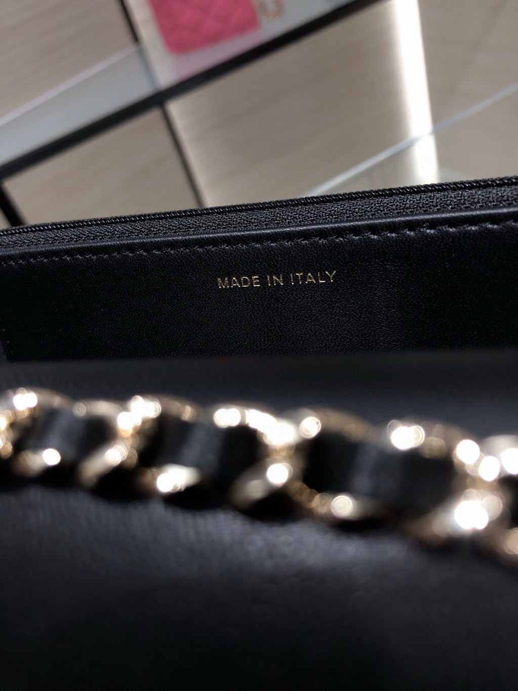 Black leather bag lining stamped 'MADE IN ITALY' with gold chain