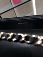 Black leather bag lining stamped 'MADE IN ITALY' with gold chain