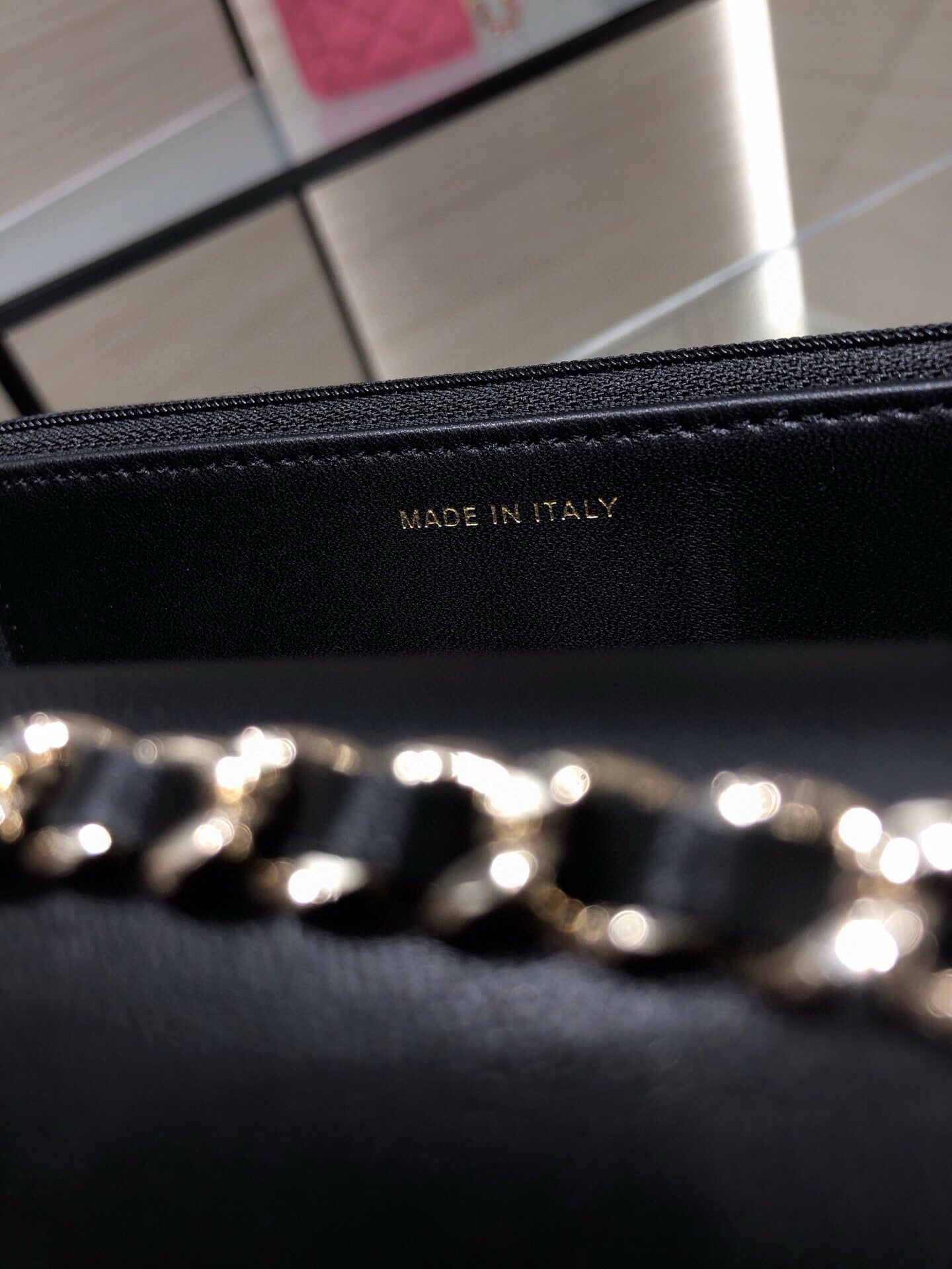 Black leather bag lining stamped 'MADE IN ITALY' with gold chain