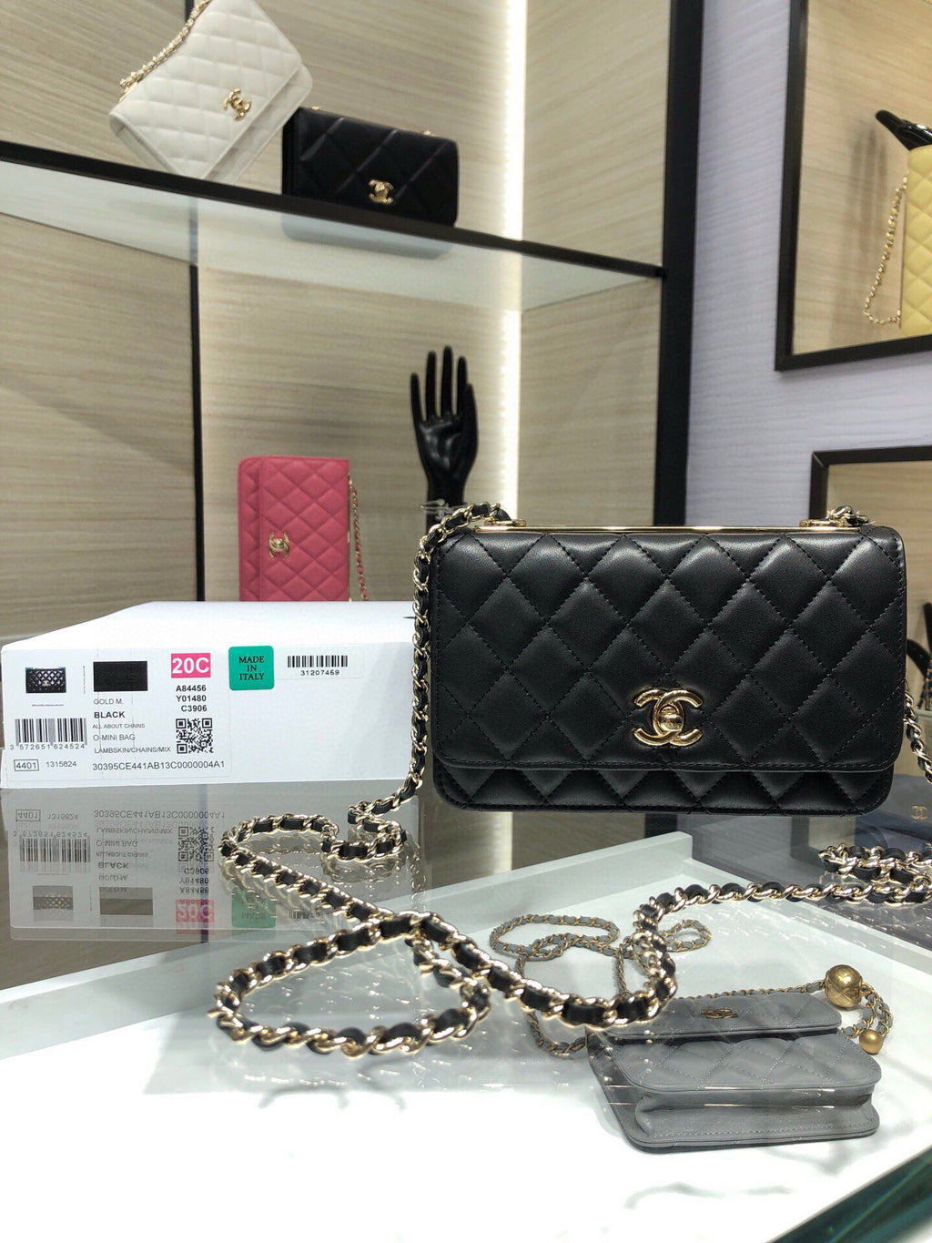Black quilted flap shoulder bag with gold Chanel logo and chain strap