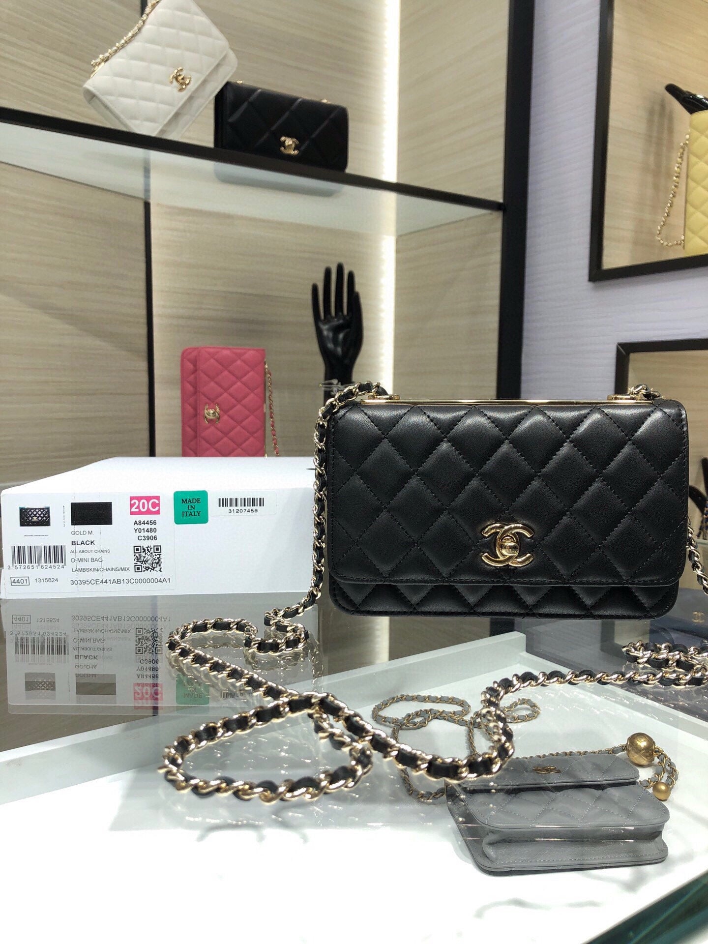 Black quilted flap shoulder bag with gold Chanel logo and chain strap
