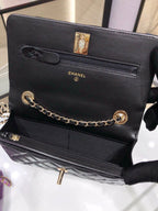 Black leather Chanel shoulder bag with gold clasp, logo, and chain strap