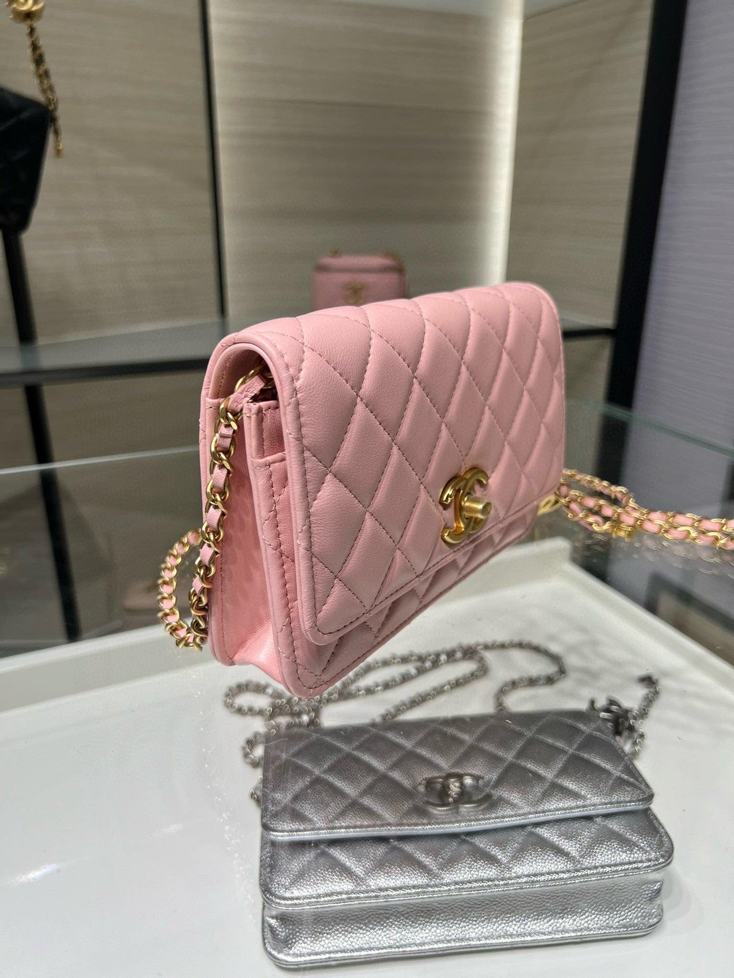 Chanel quilted pink mini crossbody bag with gold-tone chain and logo clasp