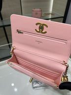 Chanel pink quilted flap bag open, showing gold-tone logo and interior compartments