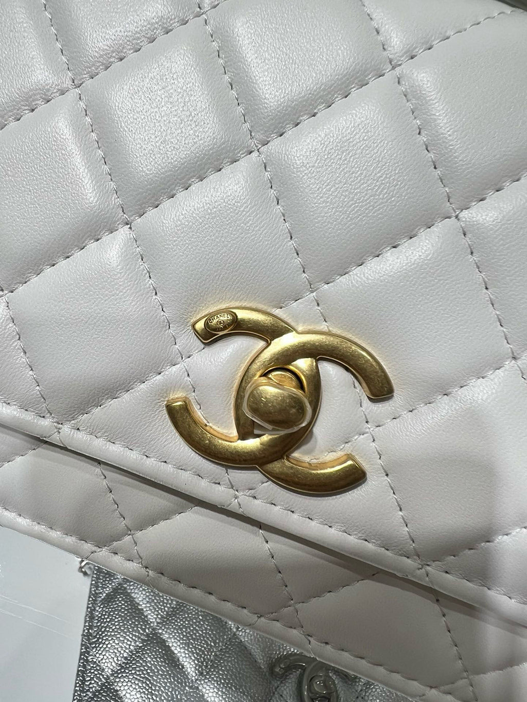 White quilted leather flap with gold Chanel logo detail.