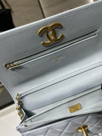 Chanel light blue quilted bag with gold CC logo and front zip pocket
