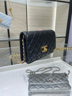 Dark quilted Chanel bag with gold logo front flap and chain strap