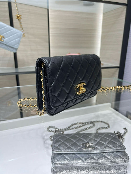 Dark quilted Chanel bag with gold logo front flap and chain strap
