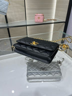 Black quilted Chanel bag with gold-tone chain strap and logo on front flap