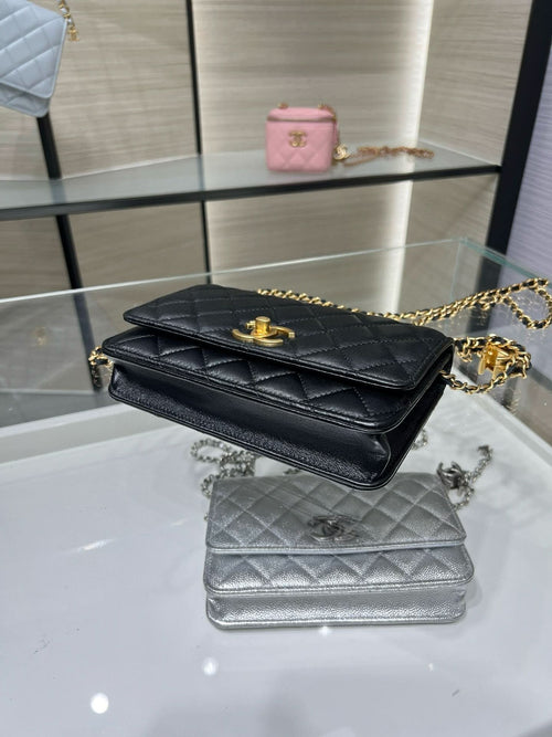 Black quilted Chanel bag with gold-tone chain strap and logo on front flap