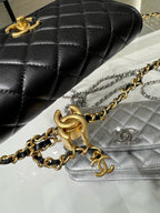Close-up black quilted Chanel bag with gold-tone chain and CC emblem