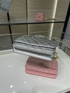 Silver and pink Chanel flap bags with chain straps and quilted texture