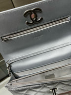 Silver Chanel bag front detail with CC logo and long zipper