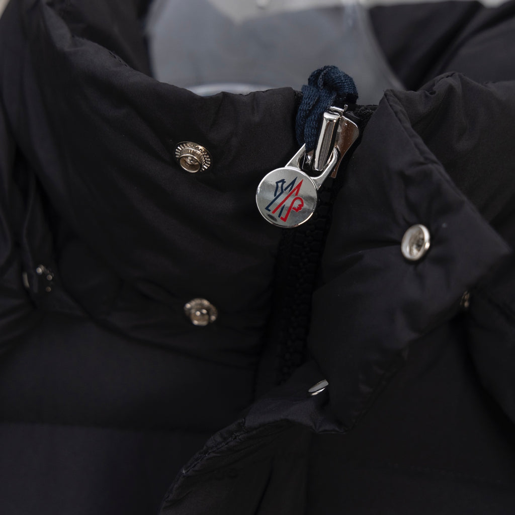 Moncler long puffer jacket chest logo and snap buttons on dark fabric