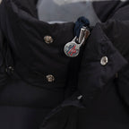 Moncler long puffer jacket chest logo and snap buttons on dark fabric
