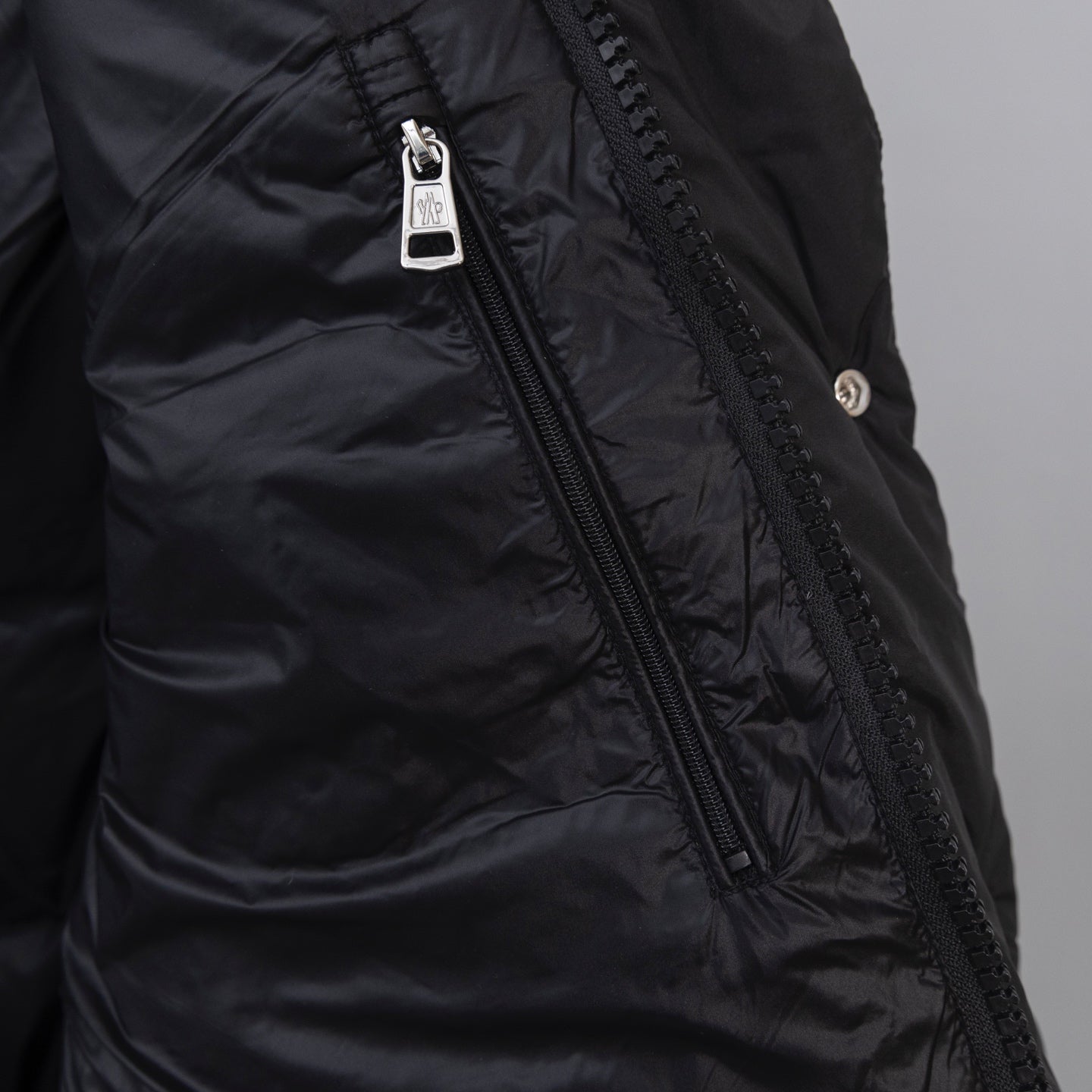 Moncler long puffer jacket front zipper with branded pull and stitched panels