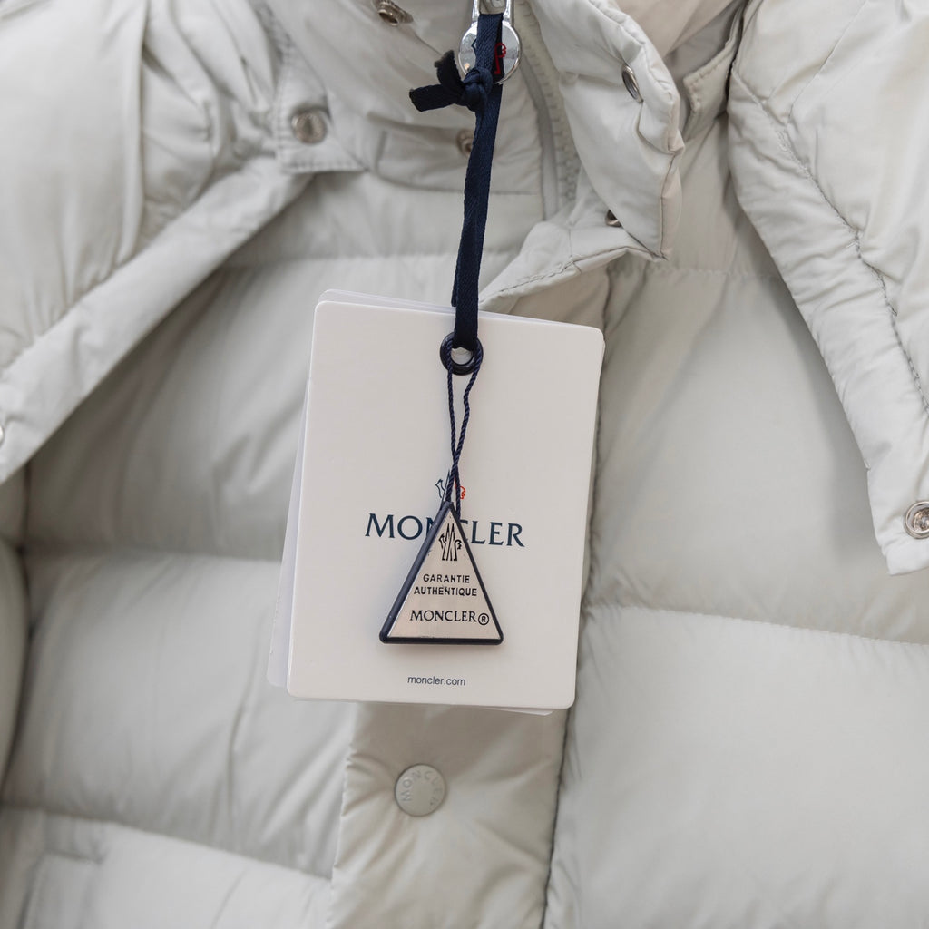 White puffer jacket with hanging logo tag and padded quilted lining