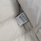 White puffer jacket lining with blue fabric care label tag