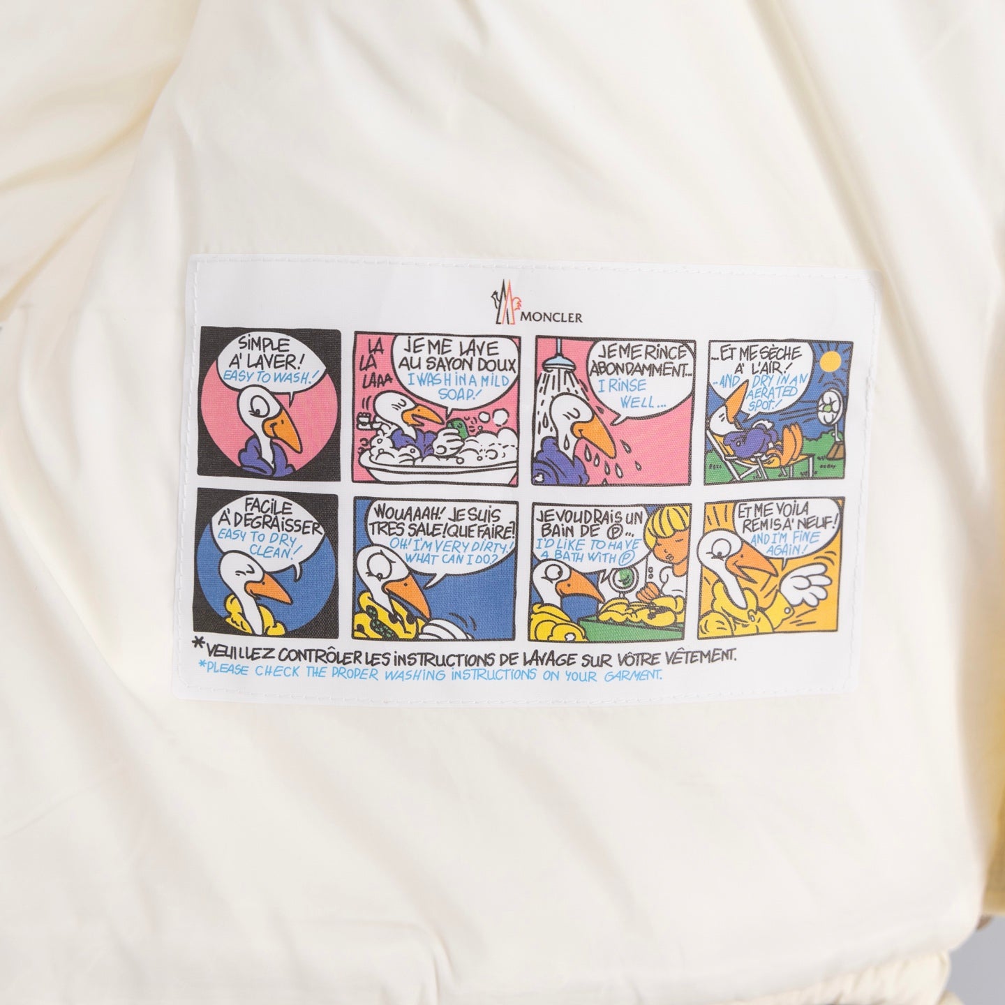 Moncler long quilted jacket lining with multicolor cartoon instruction label