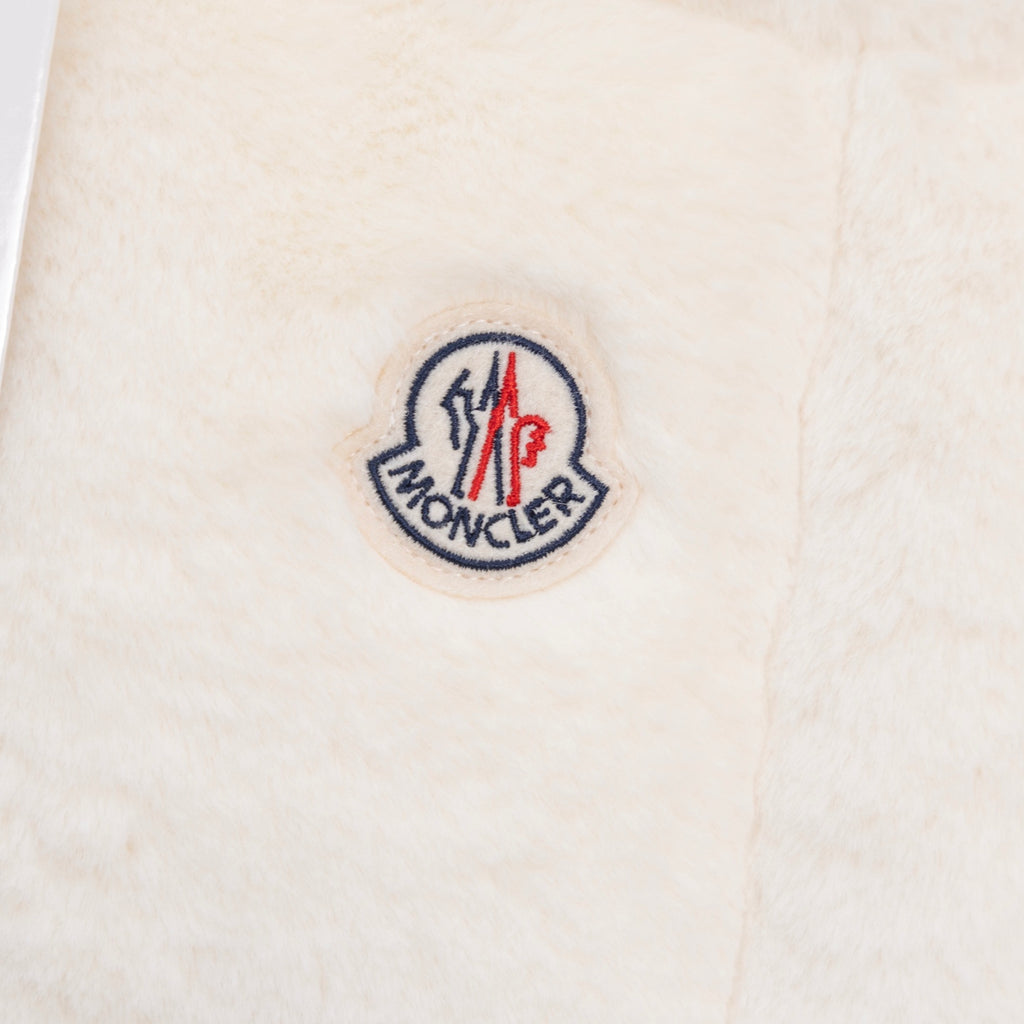 Moncler round logo patch on cream padded vest fabric