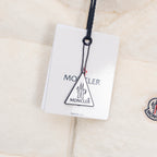 Moncler logo hang tag on cream padded vest with navy zipper pull