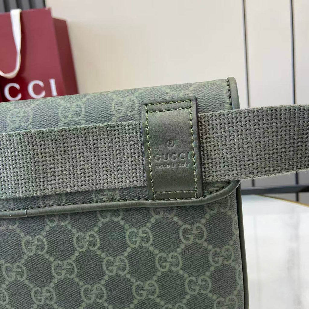 Gucci web strap attachment with leather logo patch, green and gray hardware.