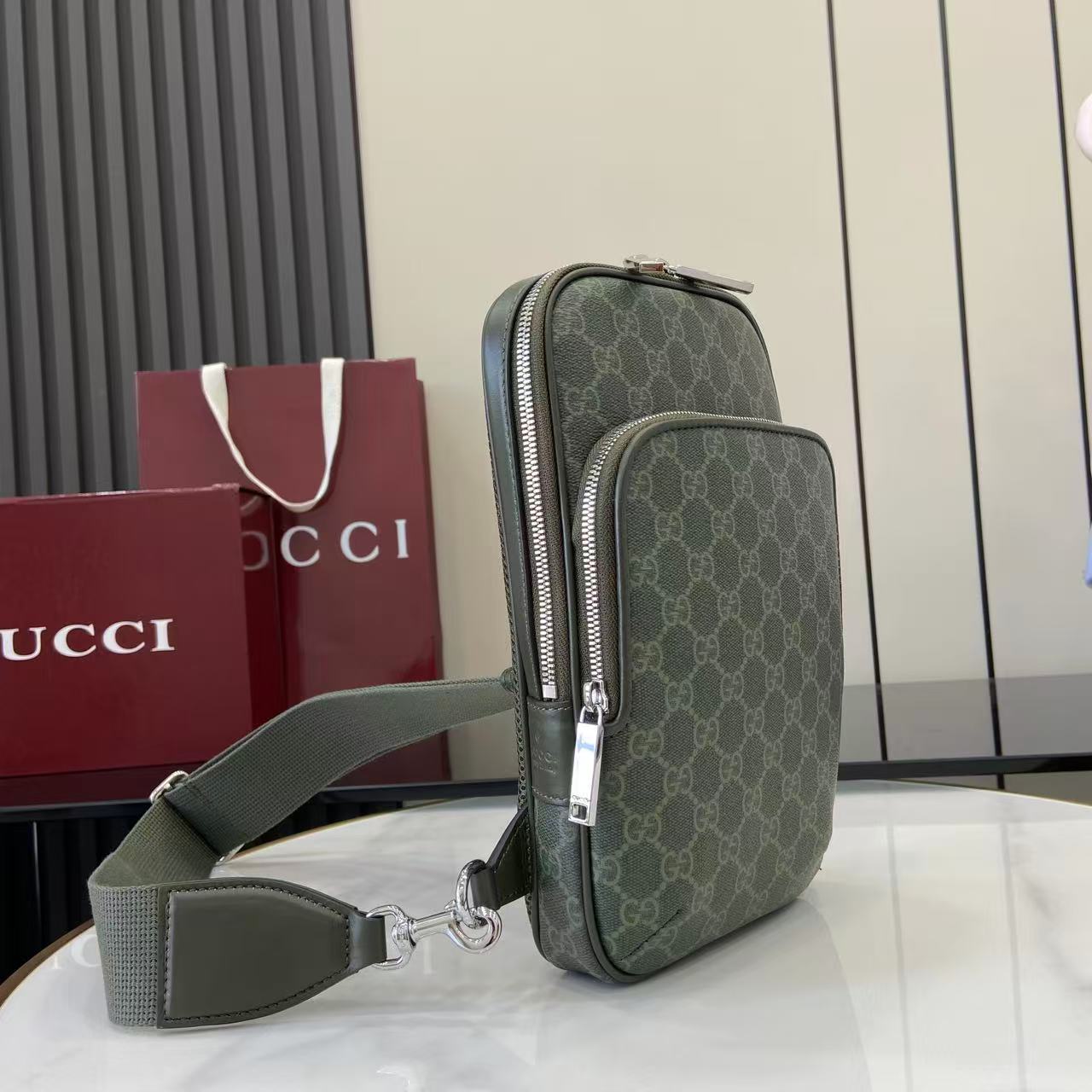 Gucci bag dark green monogram with dual-zip front pockets and adjustable strap