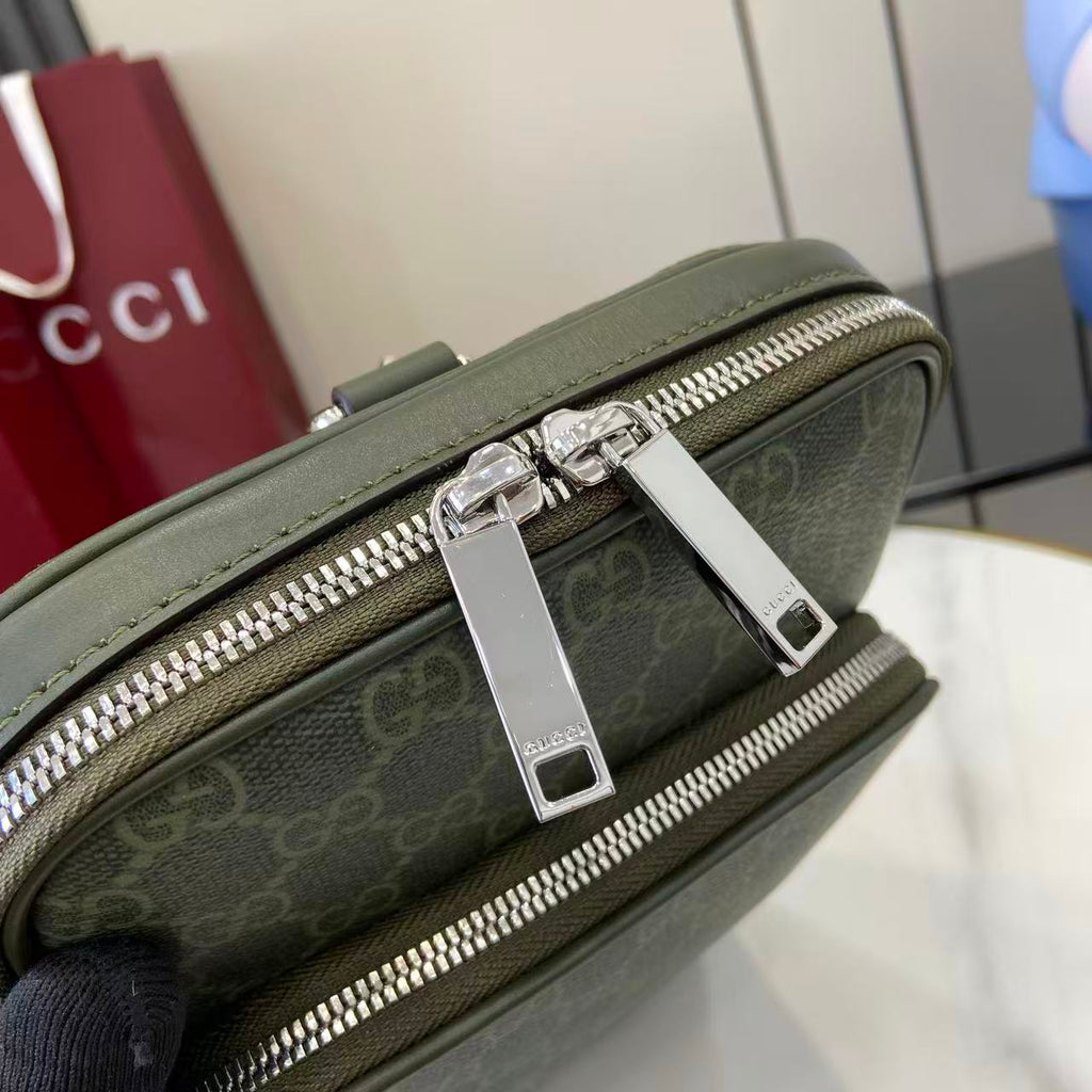 Gucci bag close-up: dark green zip pockets with rectangular silver pulls