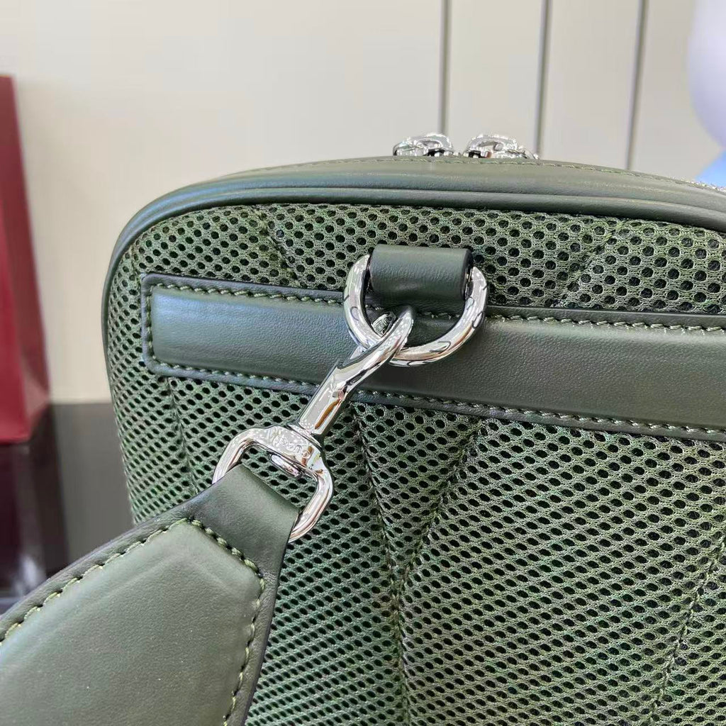 Gucci bag clasp with green mesh panel and silver-tone hardware, top close-up