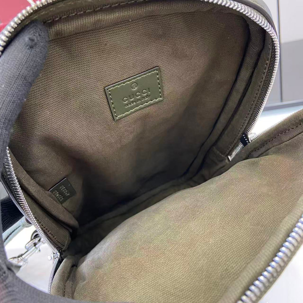 Gucci bag interior view with beige fabric lining and stitched leather logo patch