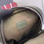 Gucci bag interior close-up showing beige lining and leather logo patch near zip