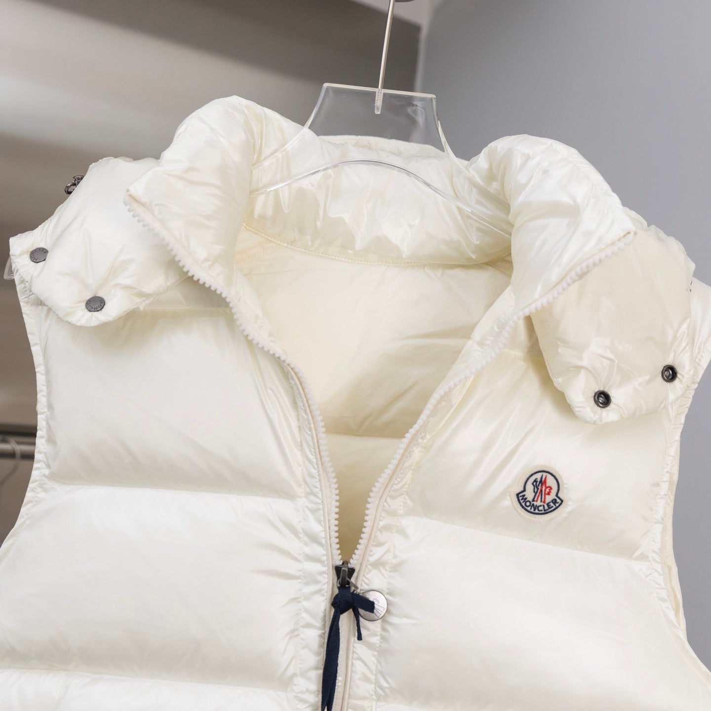 White hooded padded jacket with flap pockets and snap buttons