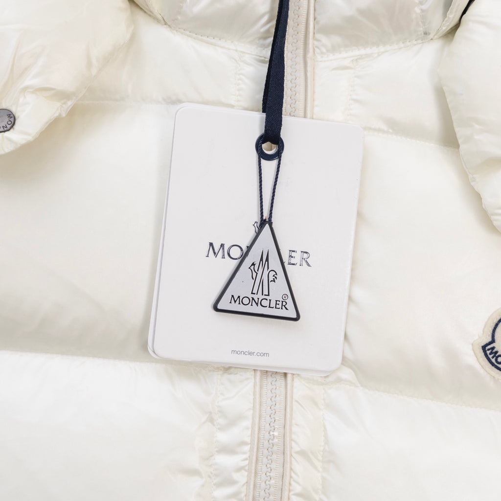 White jacket close-up with hanging tag and front zipper