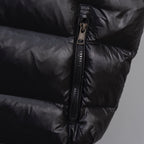Moncler long puffer jacket, front zipper detail on dark outerwear
