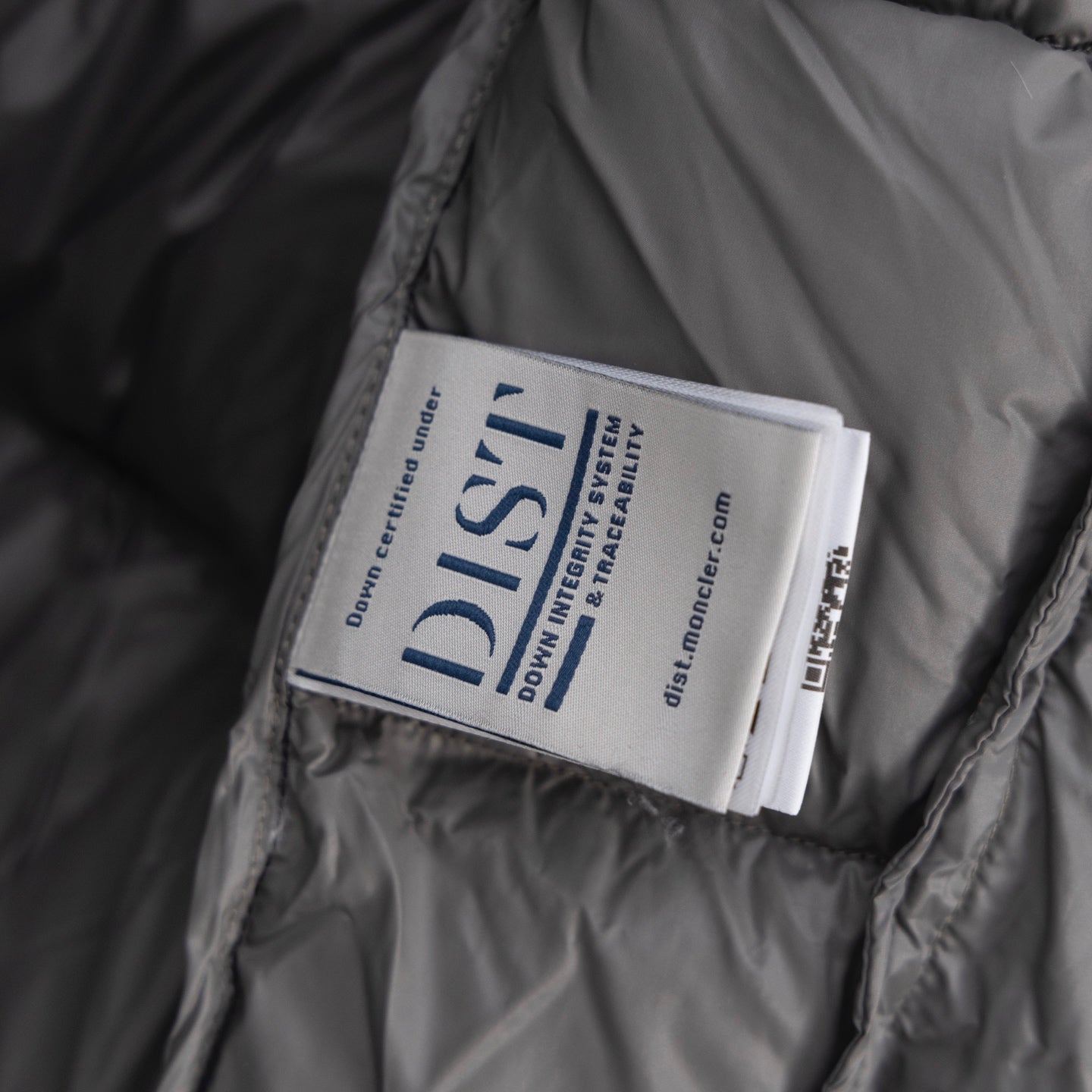 Long puffer vest inner label tag on gray lining