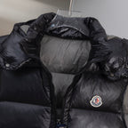 Black quilted long puffer vest with hood, front zipper, and chest logo
