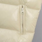 Cream padded vest close-up of center zipper and zipper pull